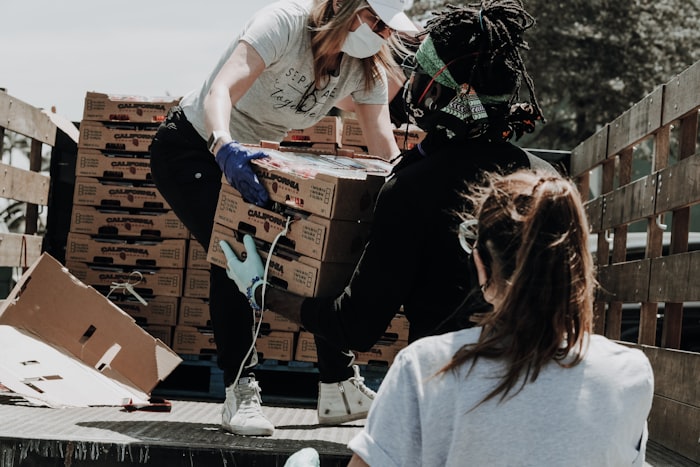 Volunteers unloading boxes of food donations