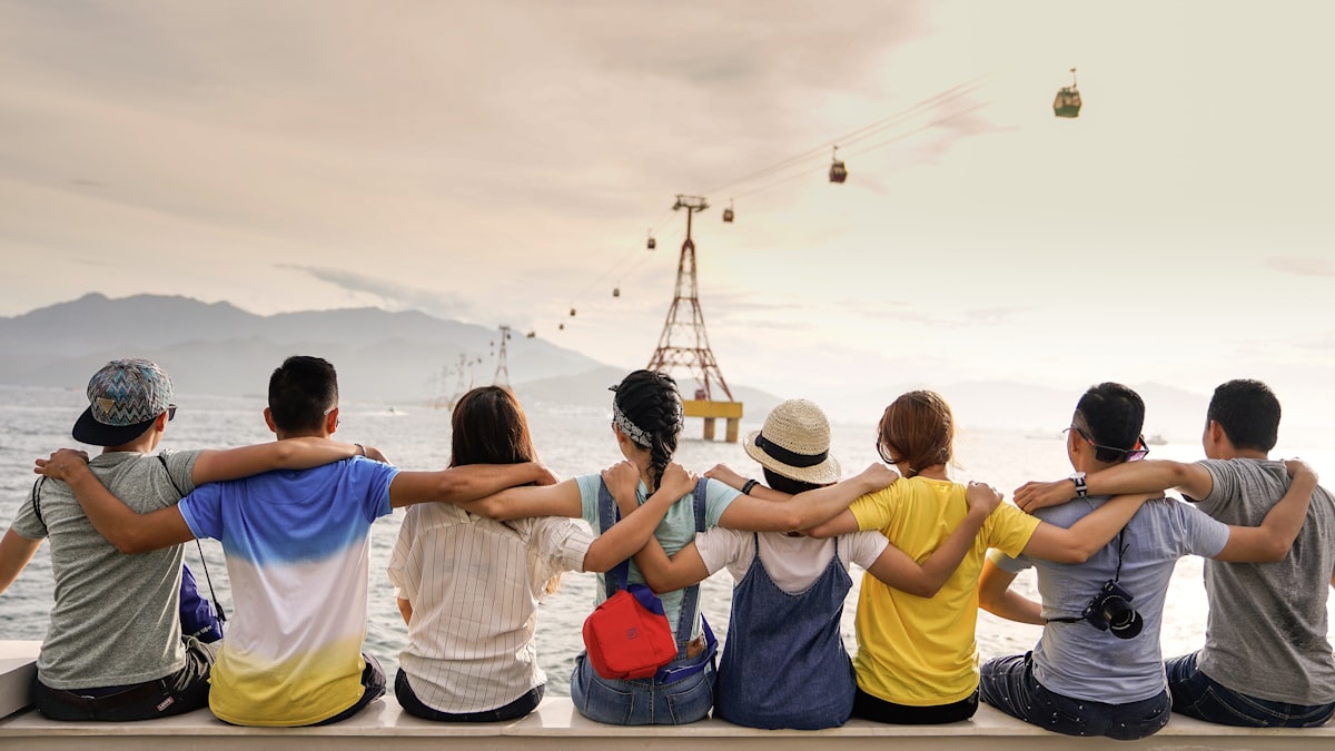 People standing together, arms around each other